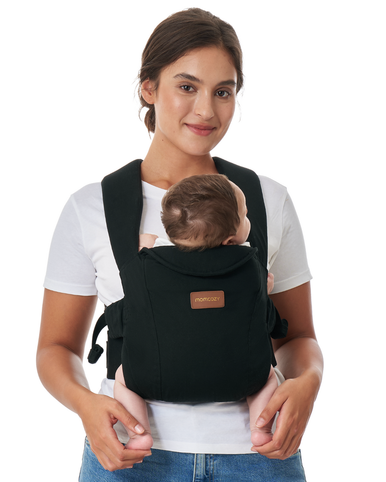 Translation missing: en.Momcozy WeeSnug Newborn Carrier (0–3M) in black, worn by a smiling mother with her baby, showcasing comfort and design